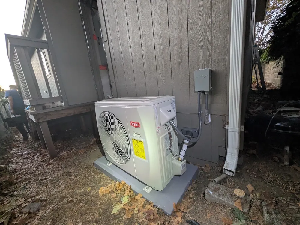 A Bryant heat pump outdoor unit on a new pad.